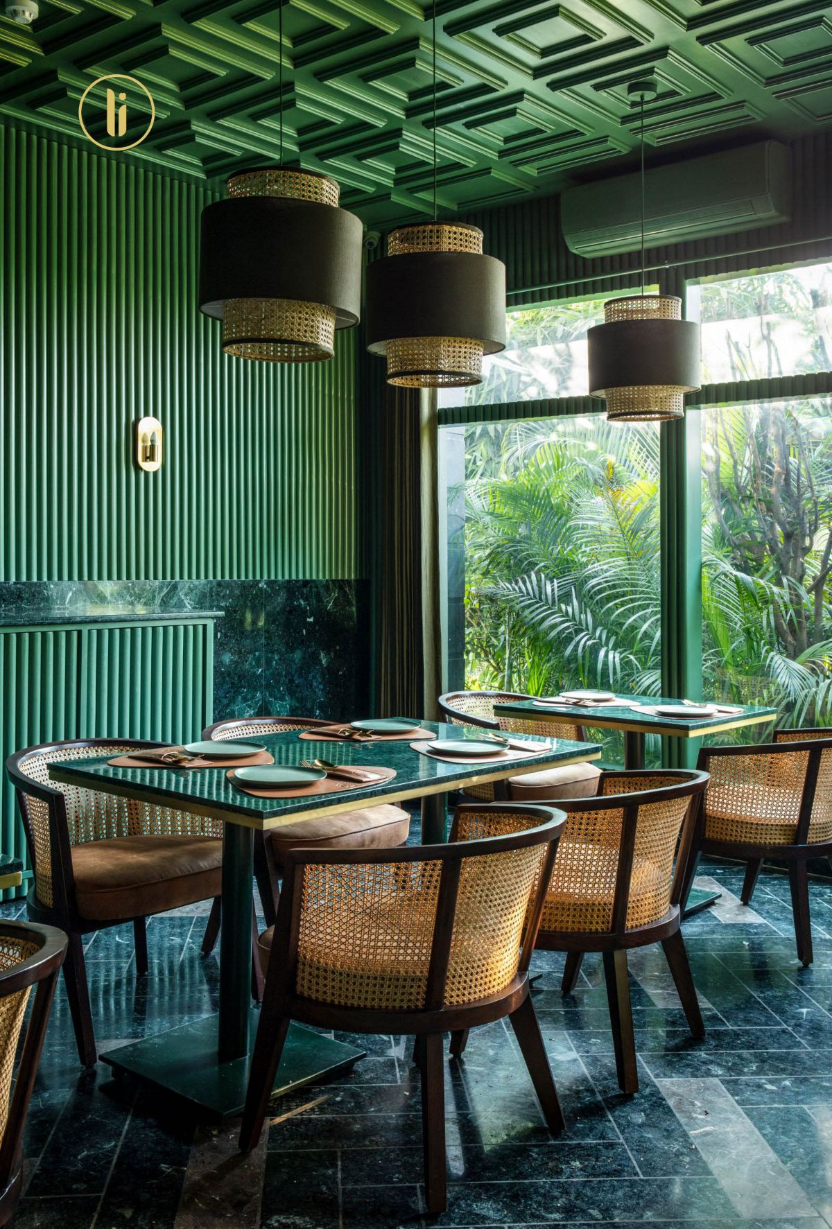 Stylish cafe interior with wooden seating and lots of plants